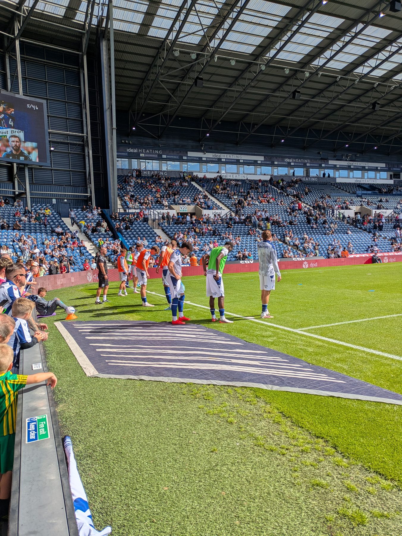 Players warming up pitchside at The Hawthorns