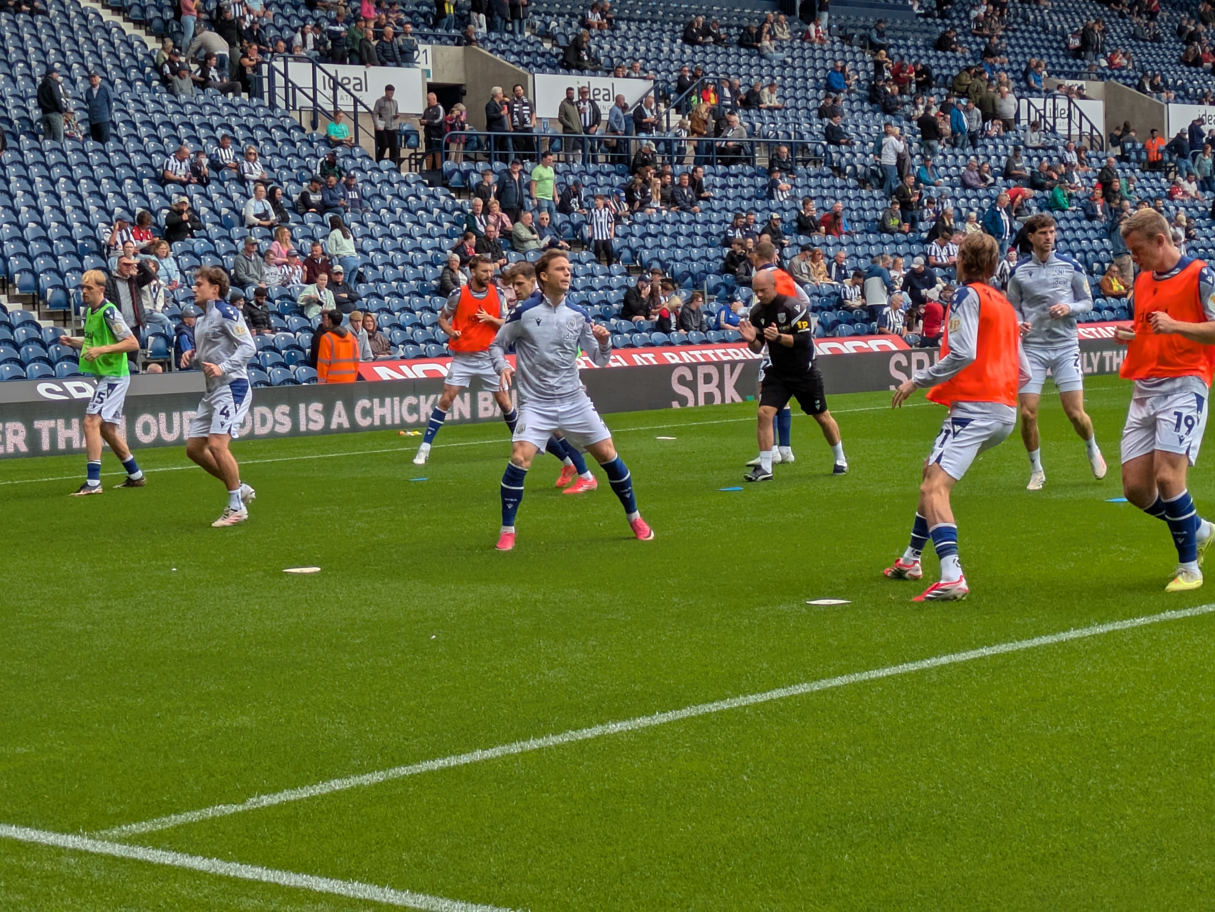 Players warming up pitchside before West Brom v QPR